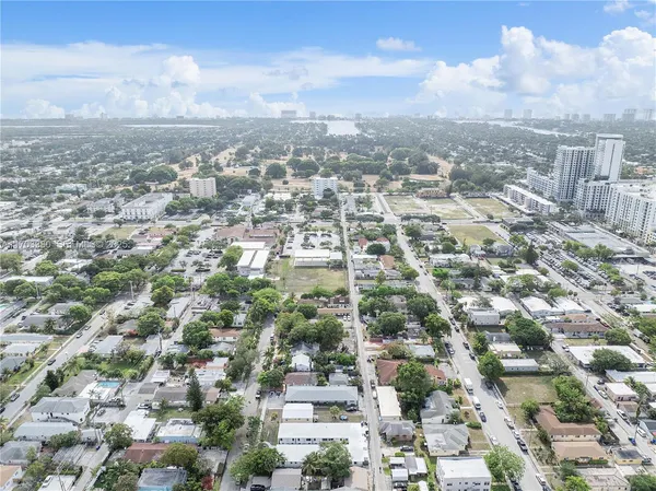 an aerial view of residential building with green space