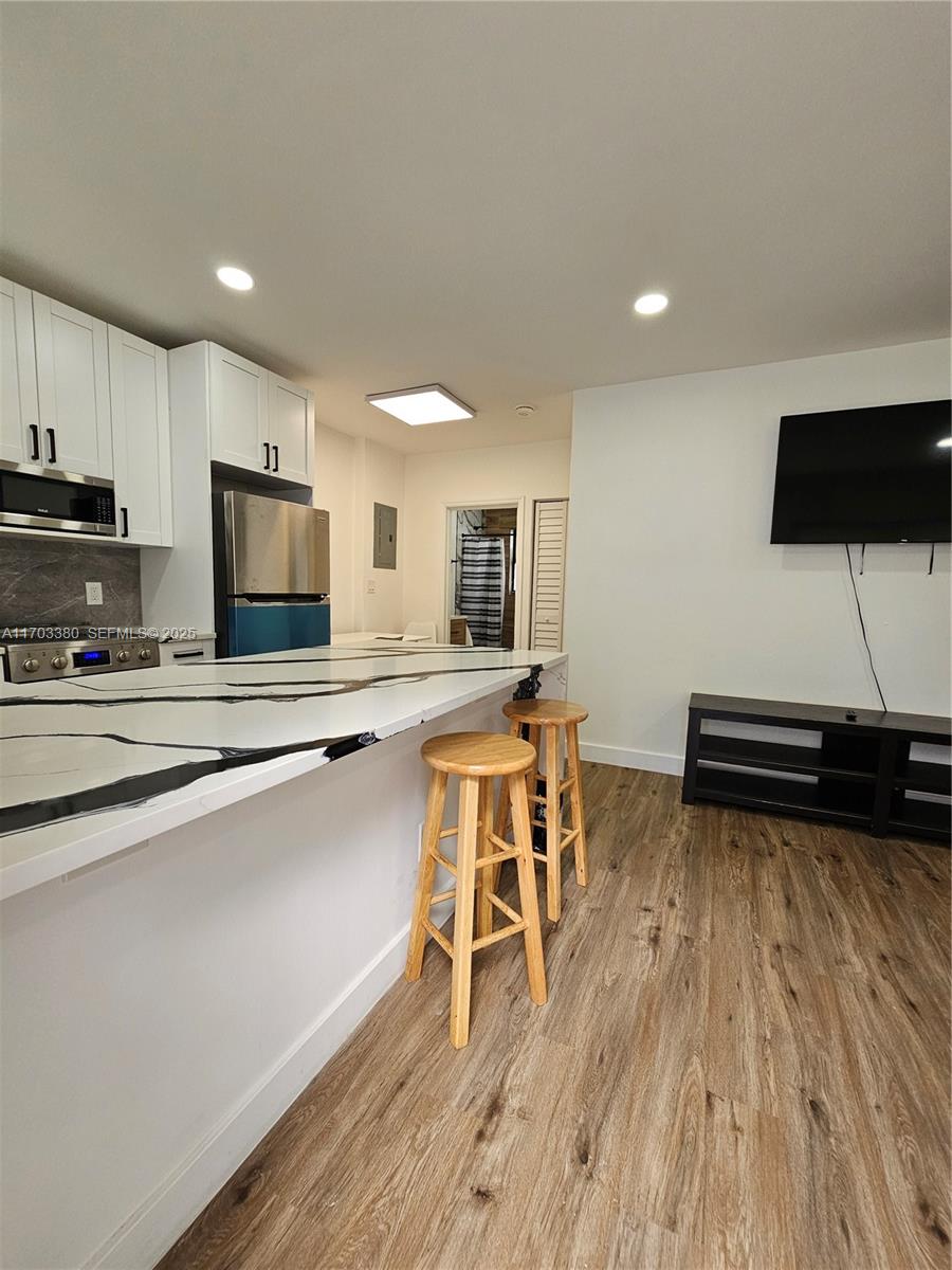 1946 Pierce Street, Unit 3 Hollywood, FL 33020 - Photo 23 of 43 a kitchen with a table and chairs in it