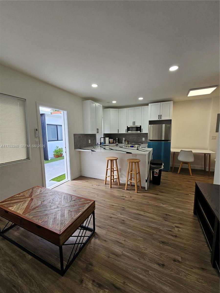 1946 Pierce Street, Unit 3 Hollywood, FL 33020 - Photo 25 of 43 a living room with stainless steel appliances furniture wooden floor and kitchen view