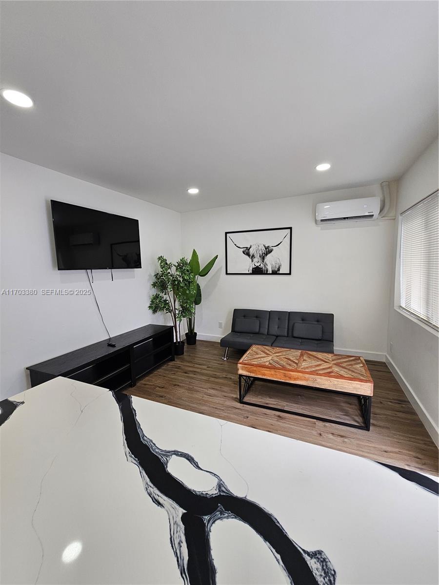 1946 Pierce Street, Unit 3 Hollywood, FL 33020 - Photo 26 of 43 a bedroom with bed and a flat screen tv