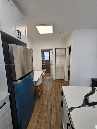 a room with wooden floor and furniture