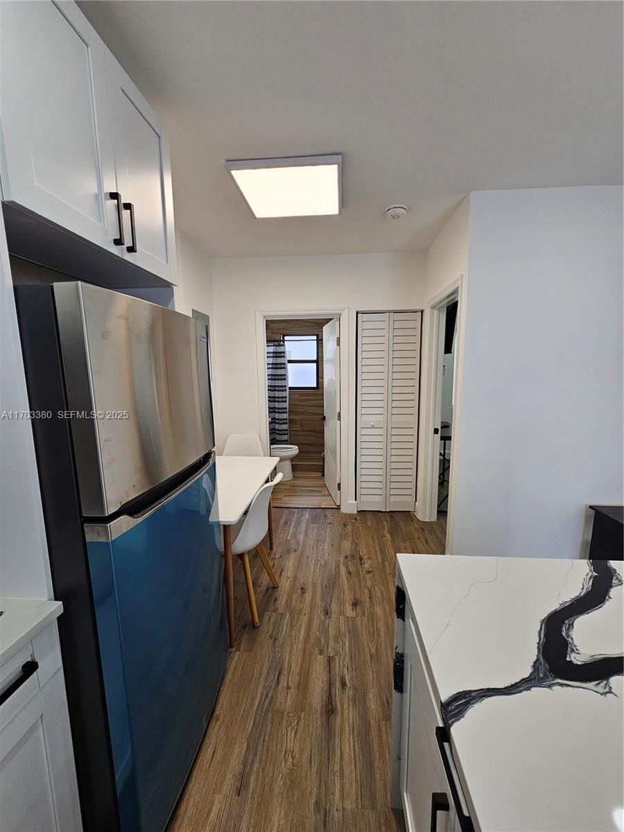 1946 Pierce Street, Unit 3 Hollywood, FL 33020 - Photo 27 of 43 a room with wooden floor and furniture