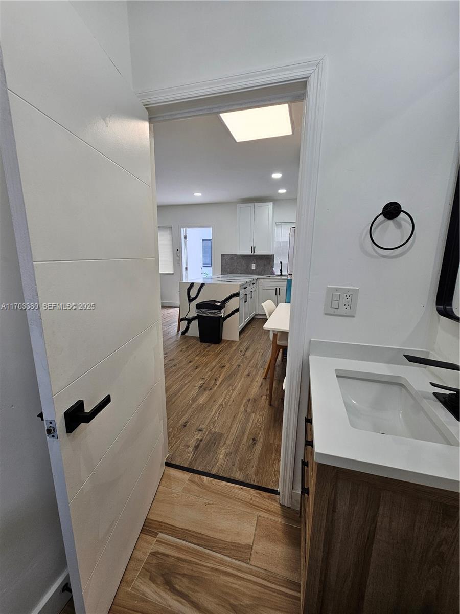 1946 Pierce Street, Unit 3 Hollywood, FL 33020 - Photo 30 of 43 a kitchen with a refrigerator sink and wooden floor