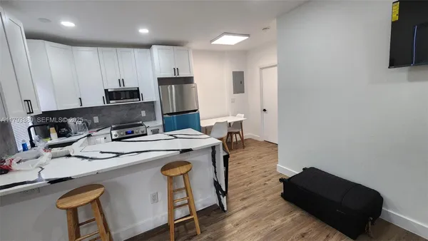 a kitchen that has a sink and a stove in it