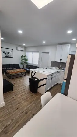 a kitchen with stainless steel appliances granite countertop a sink dishwasher stove and refrigerator