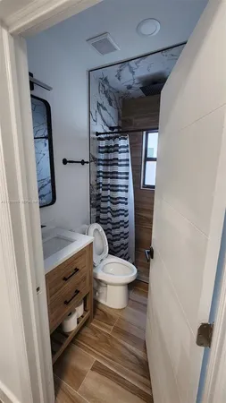 a bathroom with a toilet and a shower