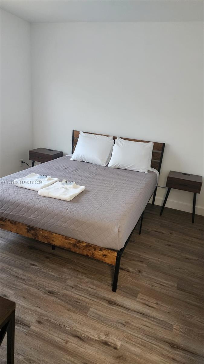 1946 Pierce Street, Unit 3 Hollywood, FL 33020 - Photo 41 of 43 a bedroom with a bed and wooden floor