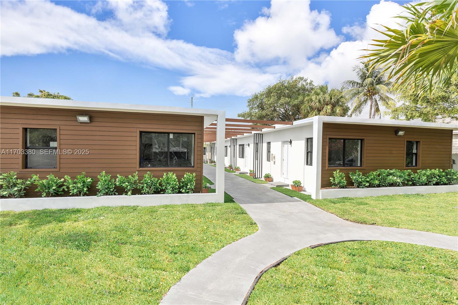 1946 Pierce Street, Unit 3 Hollywood, FL 33020 - Photo 5 of 43 a view of a house with a yard and potted plants