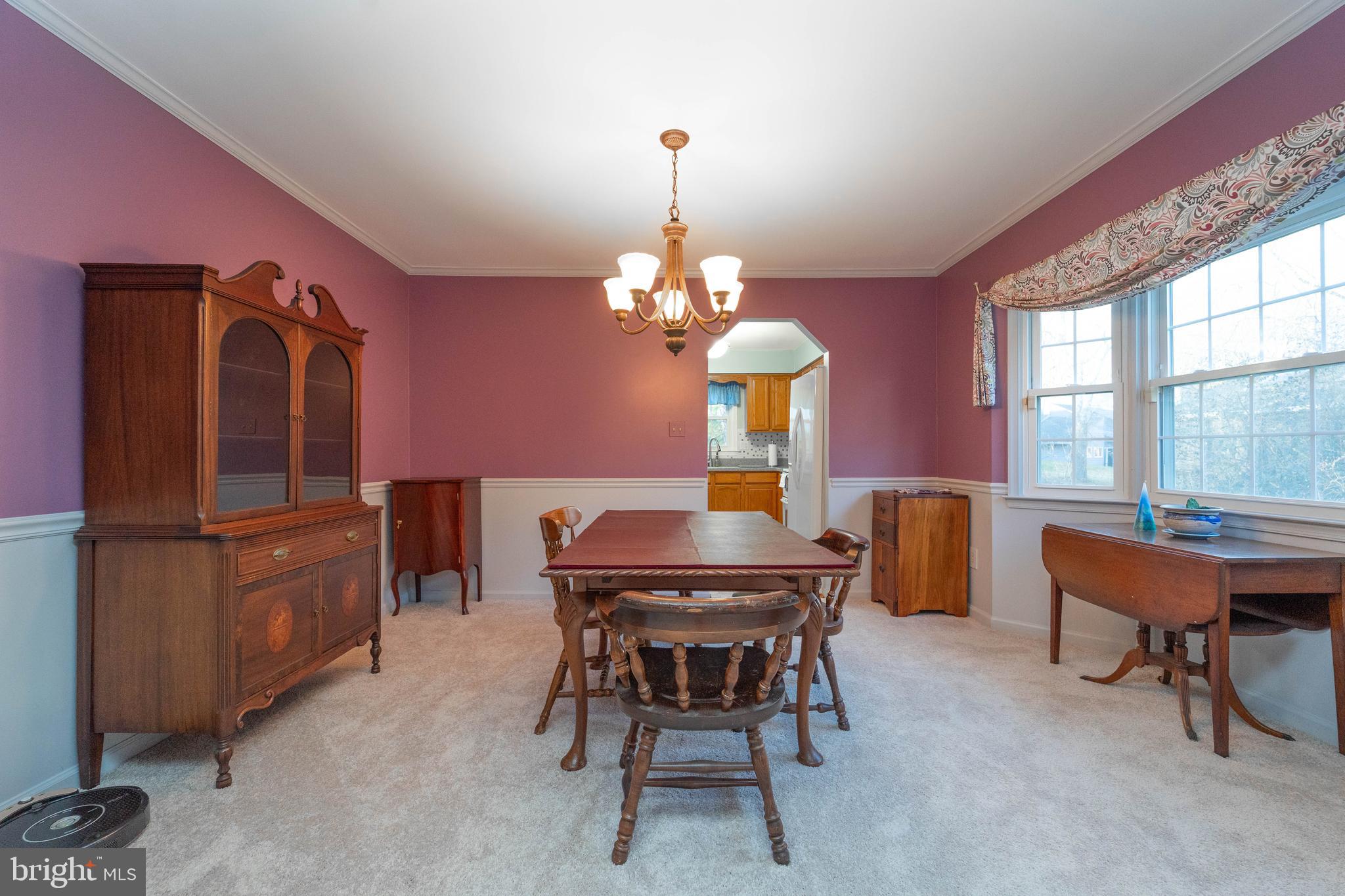 10531 Hunters Way Laurel, MD 20723 - Photo 18 of 42 a dining room with furniture a chandelier and window