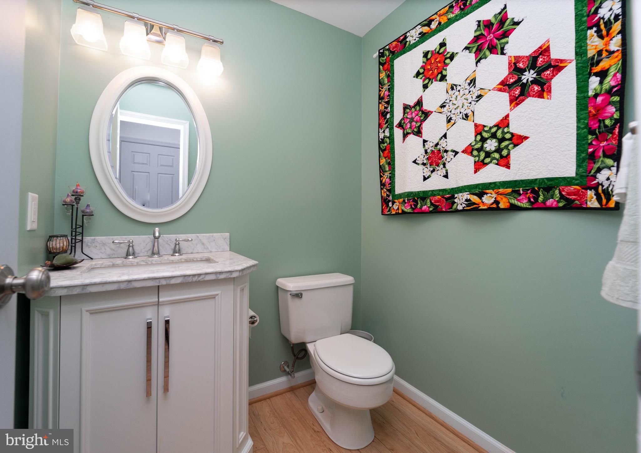 10531 Hunters Way Laurel, MD 20723 - Photo 19 of 42 a bathroom with a toilet sink and mirror