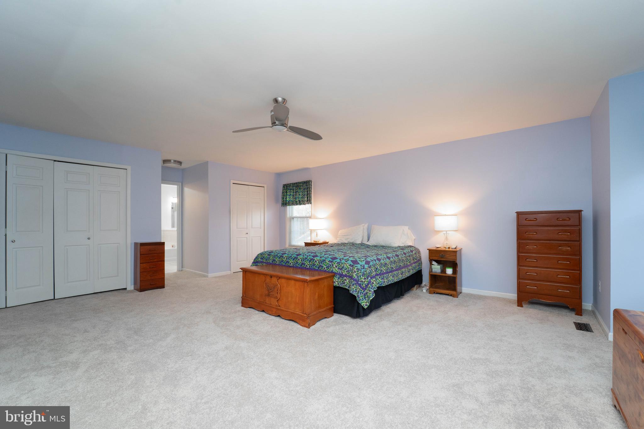 10531 Hunters Way Laurel, MD 20723 - Photo 24 of 42 a spacious bedroom with a bed and a lamp