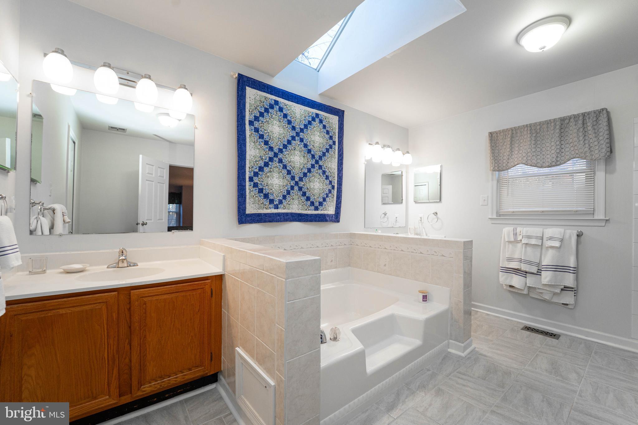 10531 Hunters Way Laurel, MD 20723 - Photo 27 of 42 a spacious bathroom with a tub sink and mirror