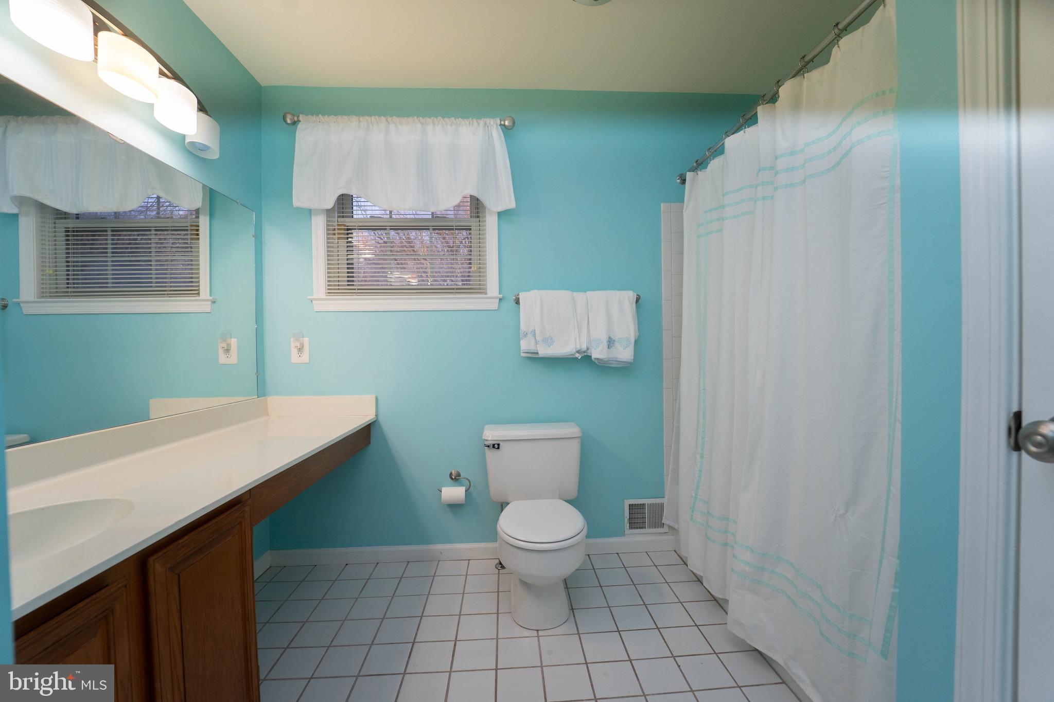 10531 Hunters Way Laurel, MD 20723 - Photo 32 of 42 a bathroom with a toilet sink and mirror