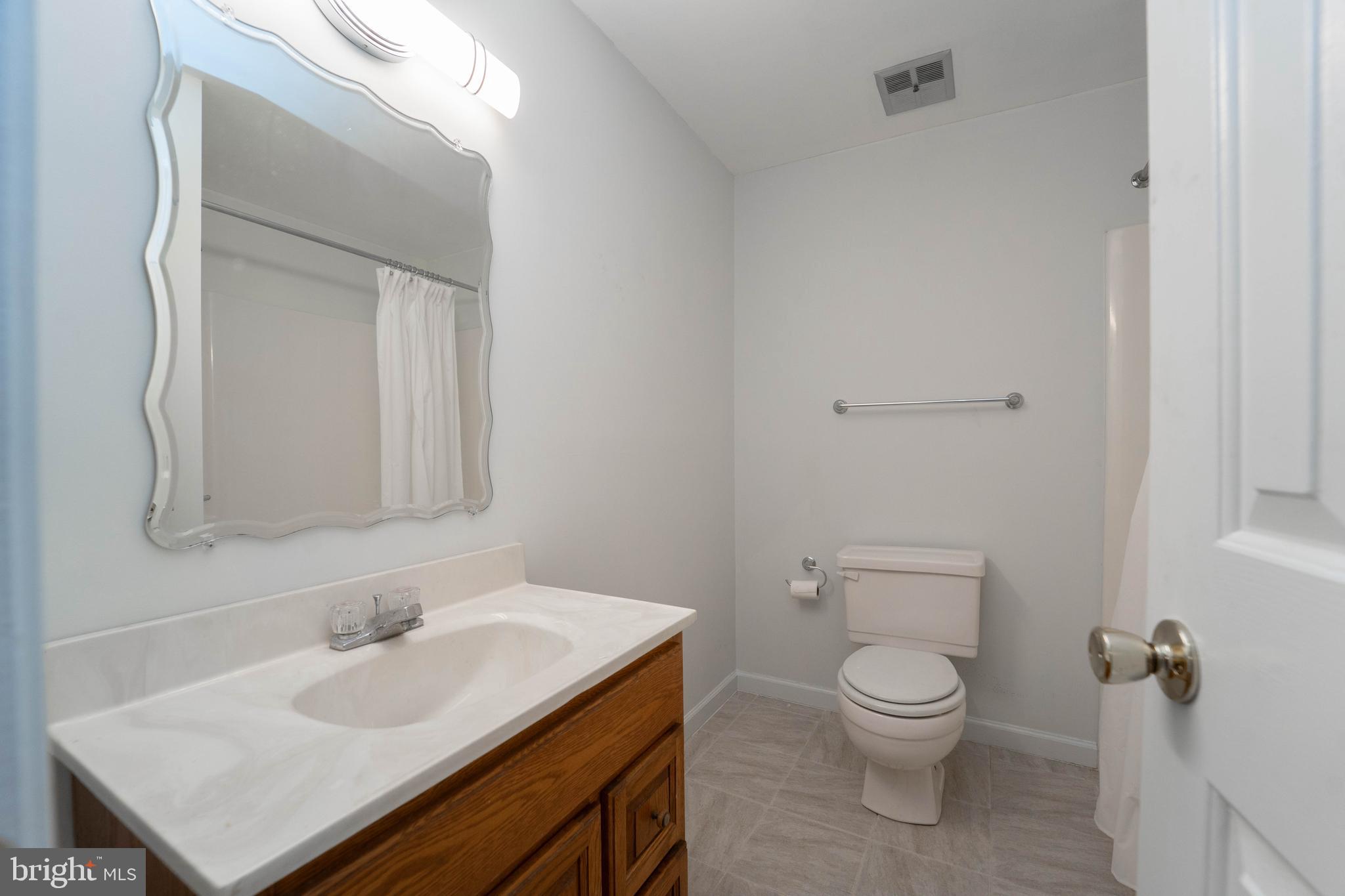 10531 Hunters Way Laurel, MD 20723 - Photo 36 of 42 a bathroom with a sink toilet and mirror