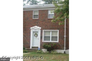 4835 Melbourne Road Baltimore, MD 21229 - Photo 1 of 7 a view of a brick house with a small yard