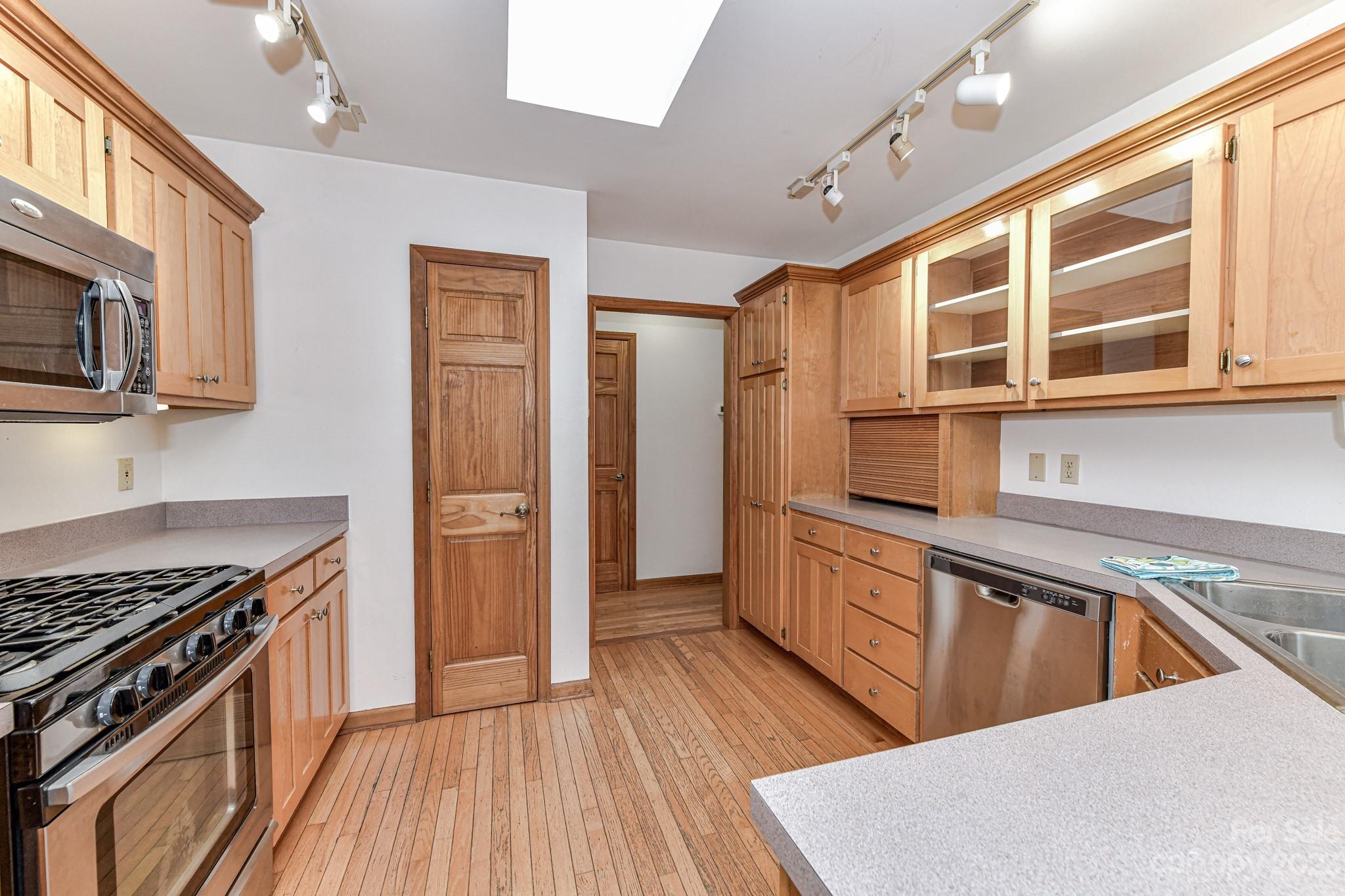 7911 Sims Road Waxhaw, NC 28173 - Photo 11 of 48 a kitchen with stainless steel appliances granite countertop a stove and a sink