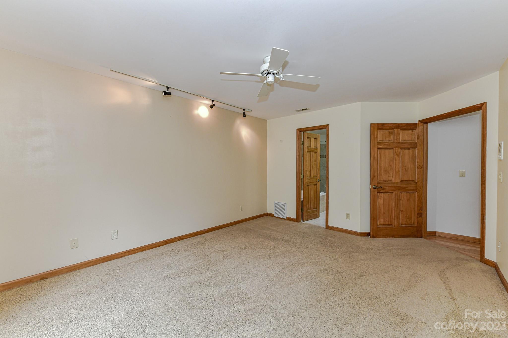 7911 Sims Road Waxhaw, NC 28173 - Photo 14 of 48 an empty room with closet and a ceiling fan