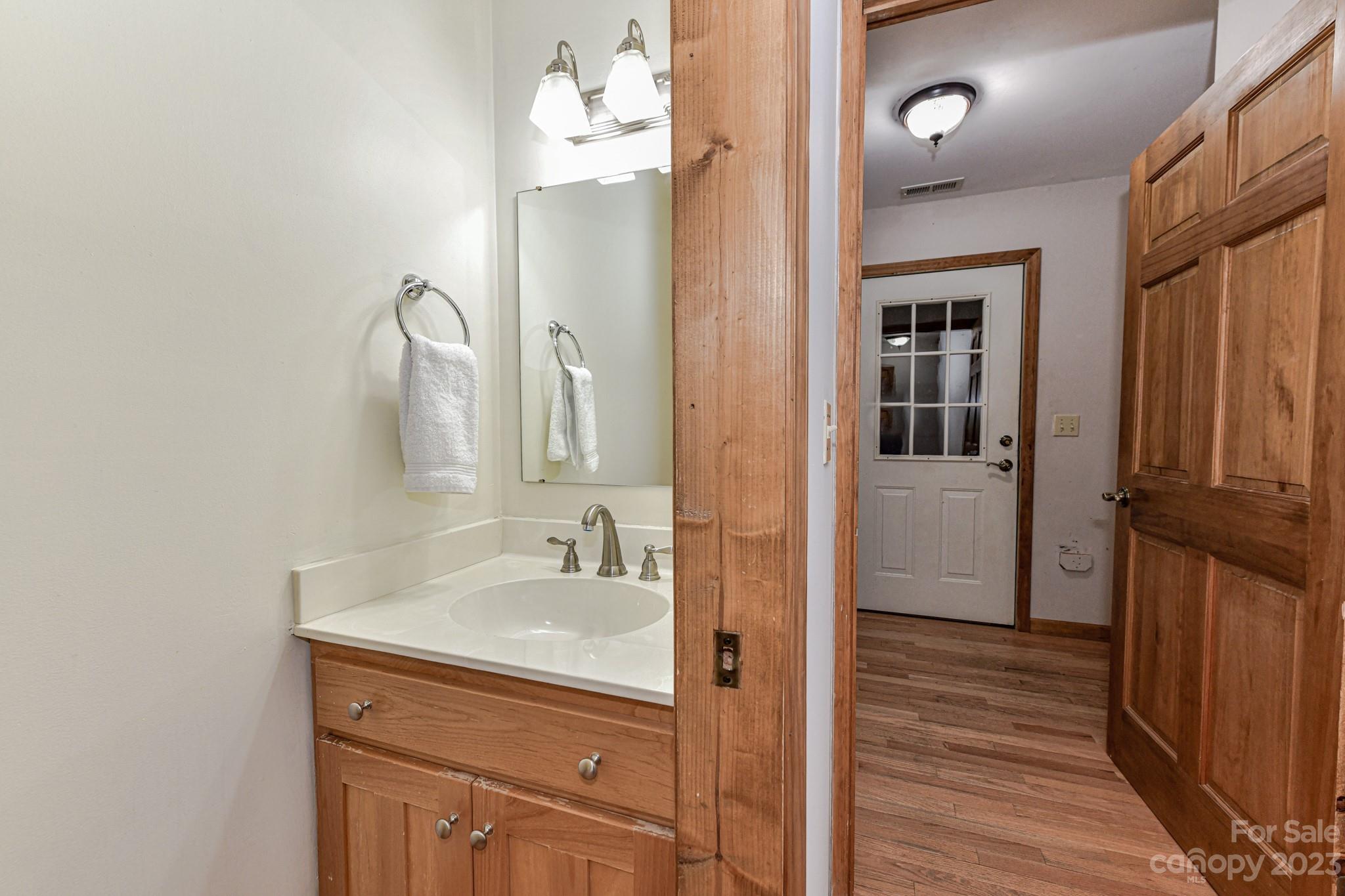 7911 Sims Road Waxhaw, NC 28173 - Photo 17 of 48 a bathroom with a sink a mirror and shower view