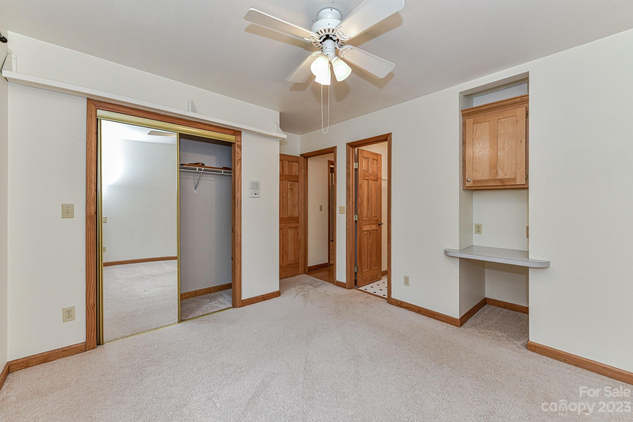 7911 Sims Road Waxhaw, NC 28173 - Photo 19 of 48 an empty room with closet and a ceiling fan