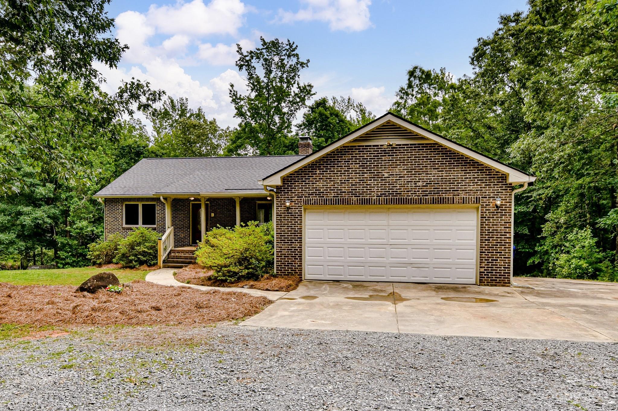 7911 Sims Road Waxhaw, NC 28173 - Photo 2 of 48 a front view of a house with a yard and garage