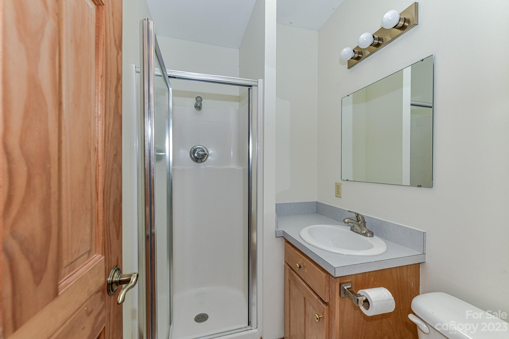 7911 Sims Road Waxhaw, NC 28173 - Photo 21 of 48 a bathroom with a granite countertop sink toilet and shower