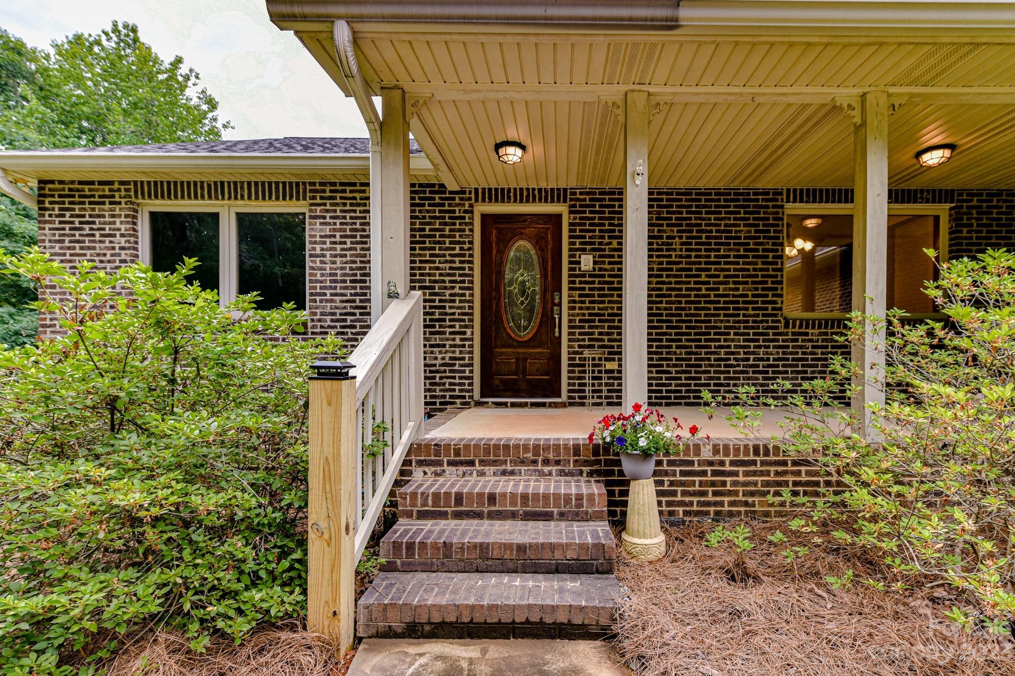 7911 Sims Road Waxhaw, NC 28173 - Photo 3 of 48 a front view of a house with a porch