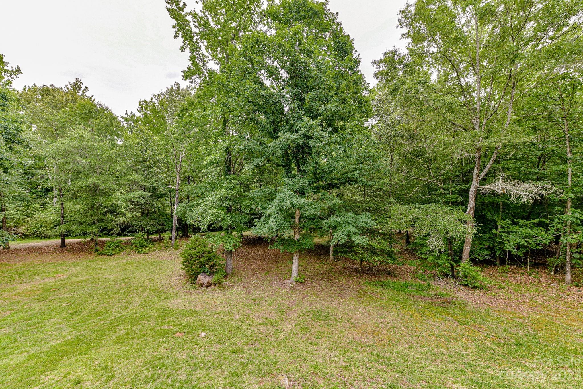 7911 Sims Road Waxhaw, NC 28173 - Photo 33 of 48 a backyard of a house with lots of green space