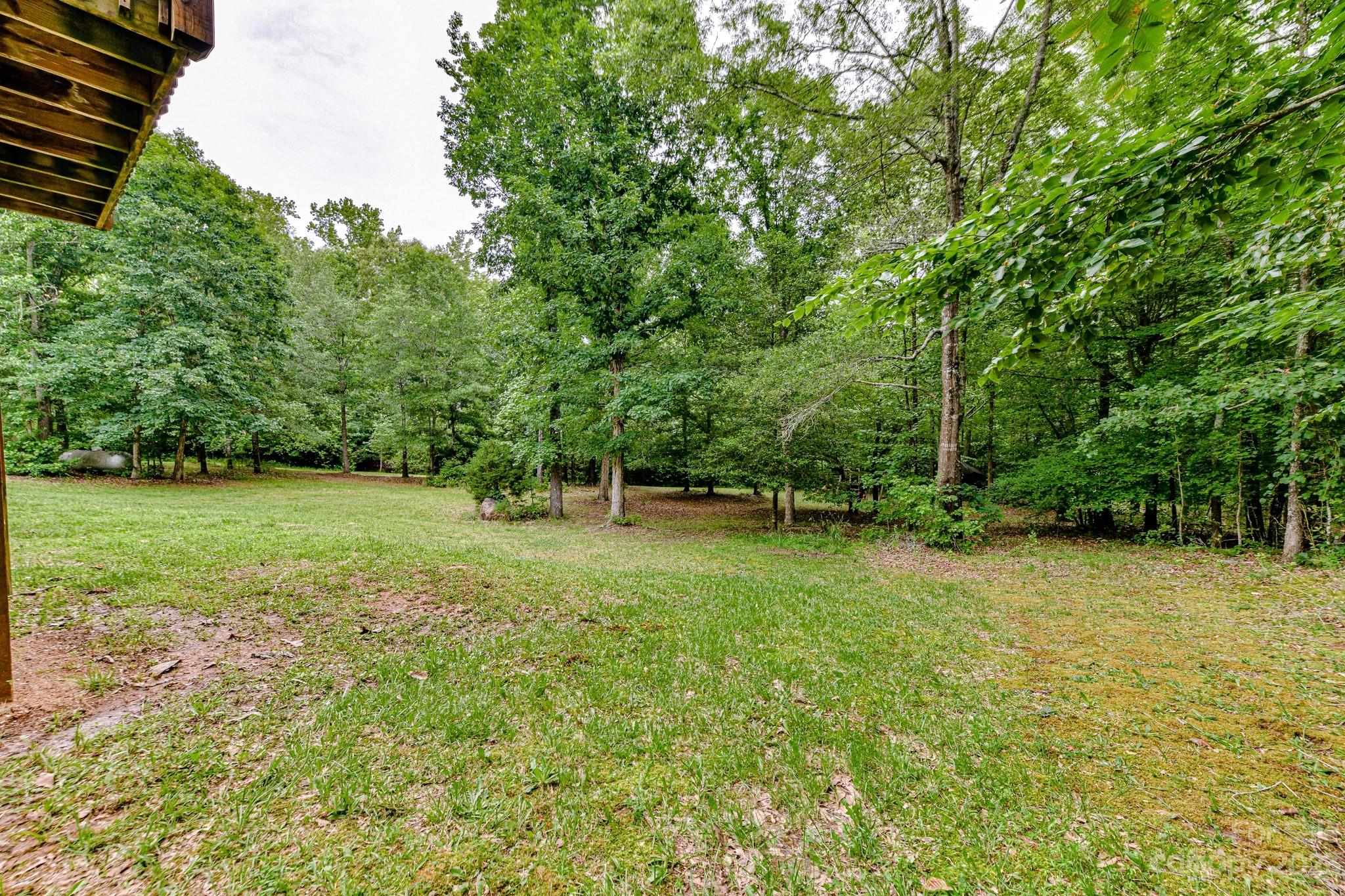 7911 Sims Road Waxhaw, NC 28173 - Photo 36 of 48 a view of a green field with trees in the background