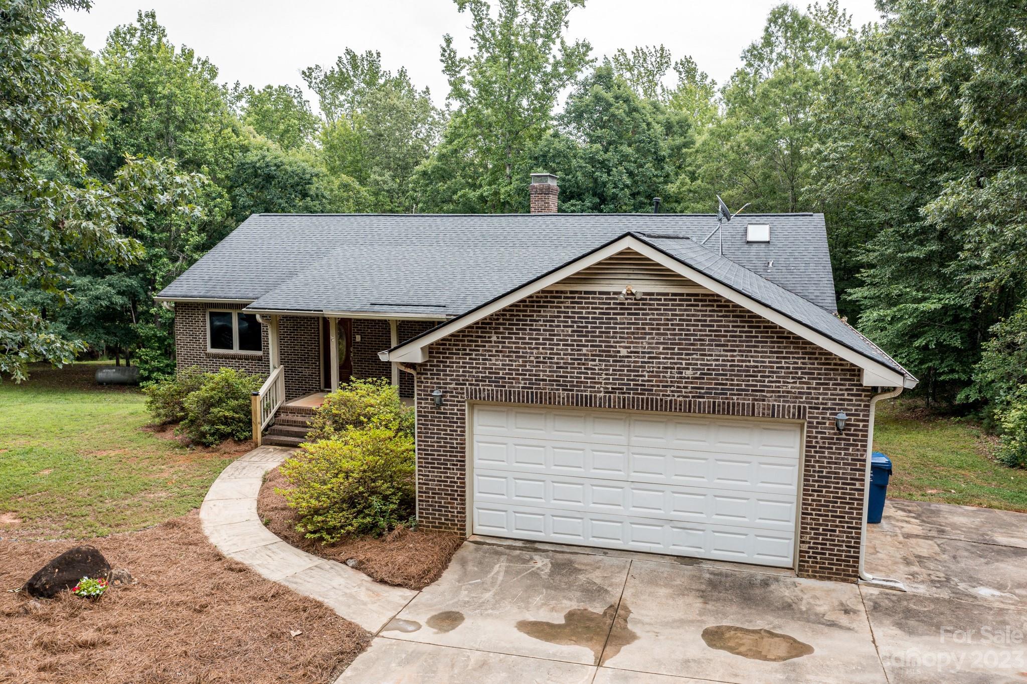 7911 Sims Road Waxhaw, NC 28173 - Photo 40 of 48 a front view of a house with a garden