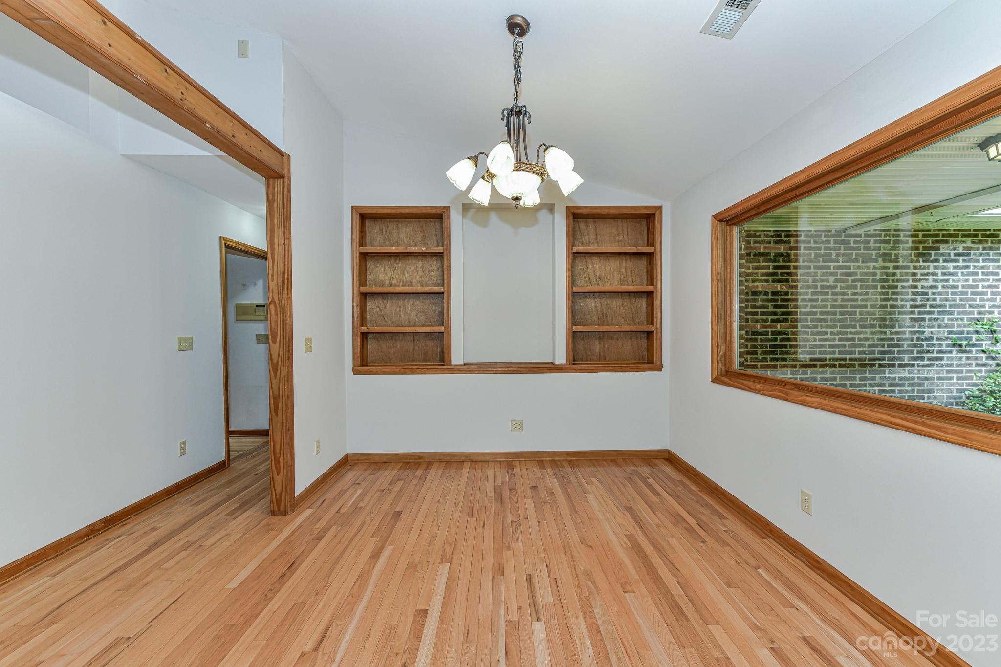 7911 Sims Road Waxhaw, NC 28173 - Photo 6 of 48 a view of a room with wooden floor chandelier and windows