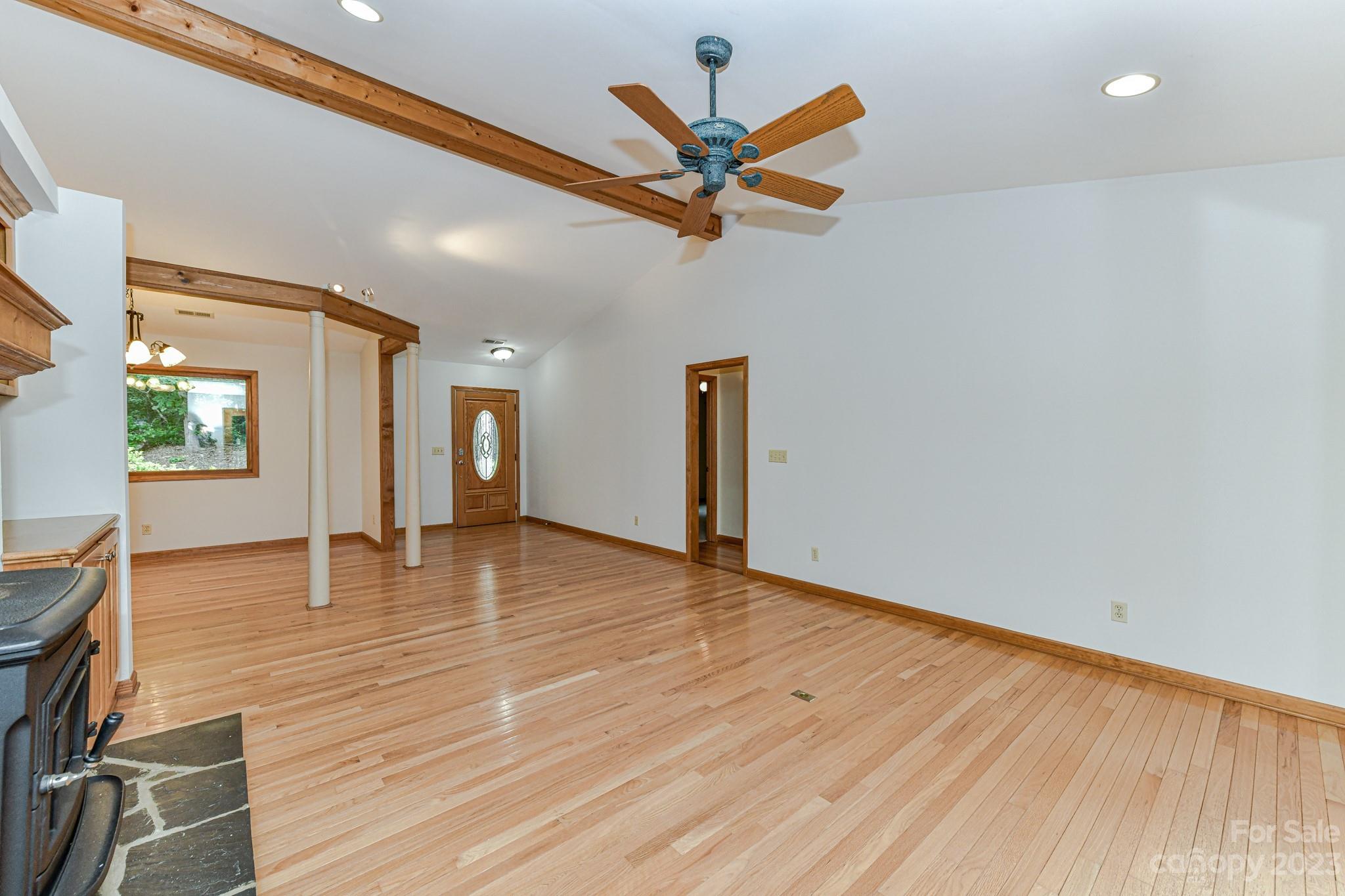 7911 Sims Road Waxhaw, NC 28173 - Photo 9 of 48 a view of empty room with wooden floor and fan
