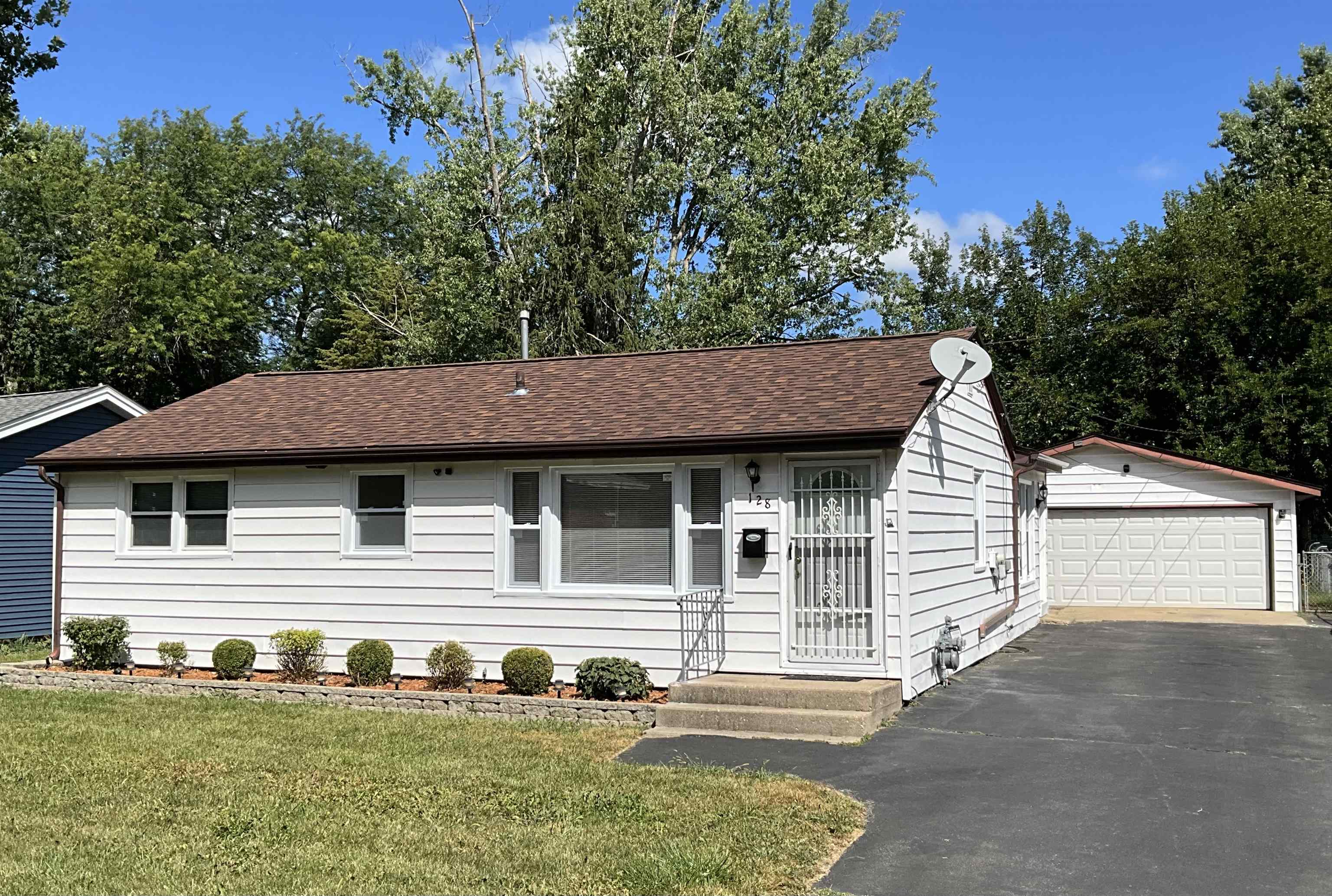 128 Wilson Avenue Machesney Park, IL 61115 - Photo 1 of 15 a front view of house with yard