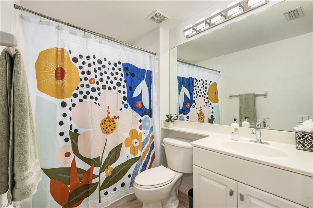 10045 Heather Lane, Unit 203 Naples, FL 34119 - Photo 12 of 30 a bathroom with a sink toilet and shower