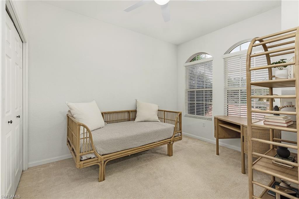 10045 Heather Lane, Unit 203 Naples, FL 34119 - Photo 13 of 30 a bedroom with a bed and a window
