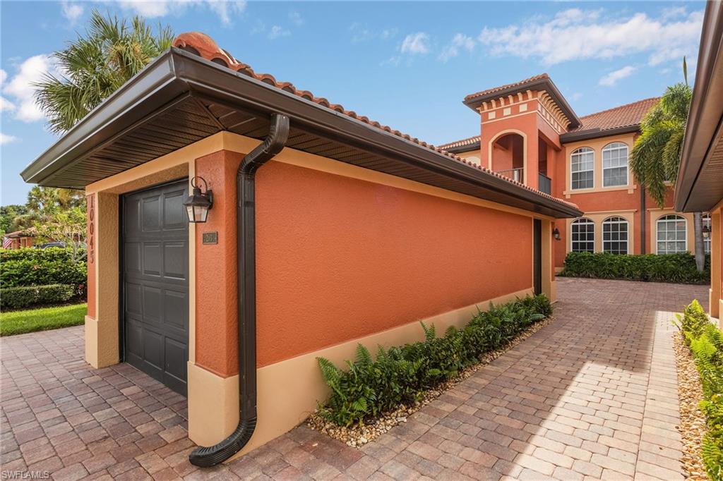 10045 Heather Lane, Unit 203 Naples, FL 34119 - Photo 16 of 30 a front view of a house with a garden