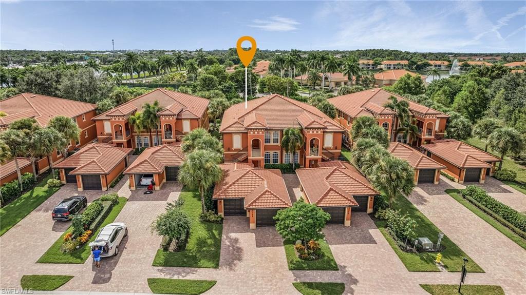 10045 Heather Lane, Unit 203 Naples, FL 34119 - Photo 19 of 30 an aerial view of multiple houses with a yard