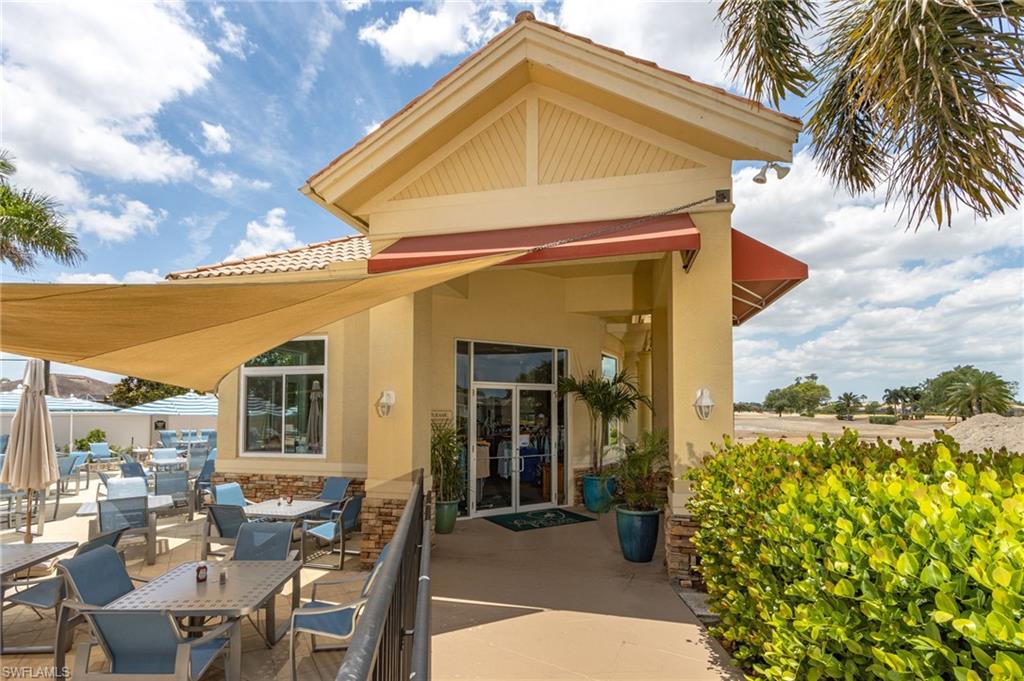 10045 Heather Lane, Unit 203 Naples, FL 34119 - Photo 24 of 30 a view of a house with a outdoor space