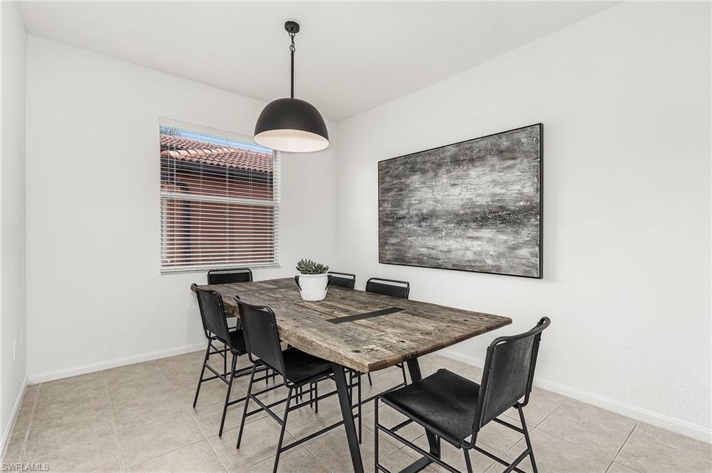 10045 Heather Lane, Unit 203 Naples, FL 34119 - Photo 6 of 30 a view of a dining room with a table and chairs