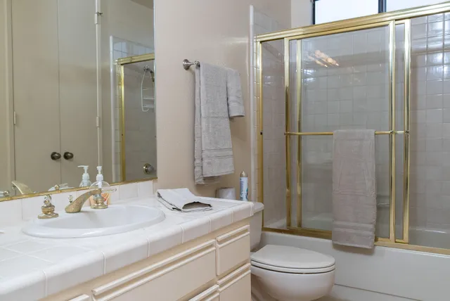 a bathroom with a sink toilet and shower