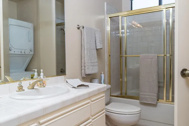 a bathroom with a sink toilet and shower