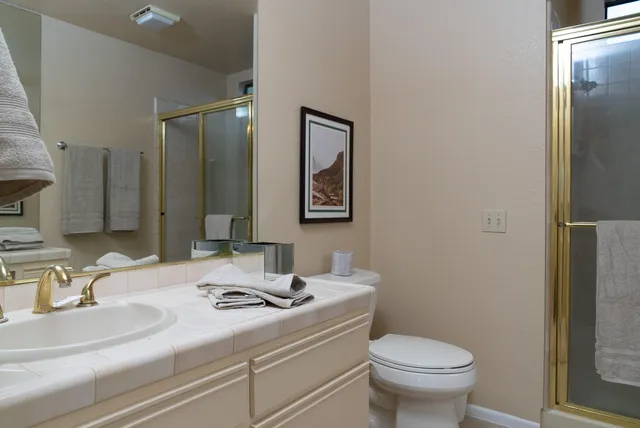 a bathroom with a sink toilet and mirror
