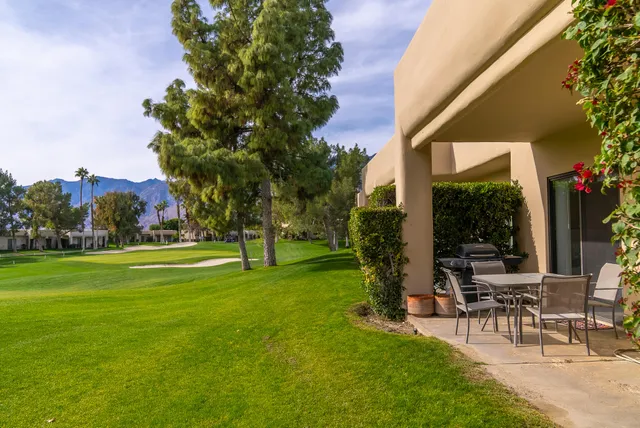a view of a patio with a table and chairs