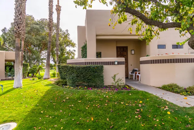 a view of a house with backyard and garden