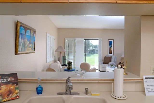 a kitchen with a sink a counter and cabinets