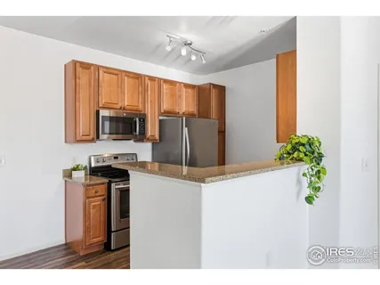 a kitchen with kitchen island a counter top space appliances and cabinets