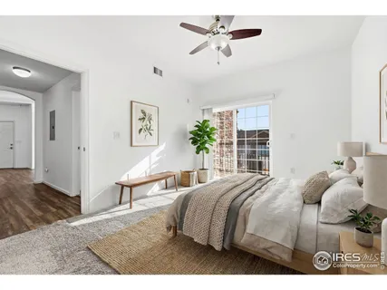a bedroom with a bed a window and a potted plant