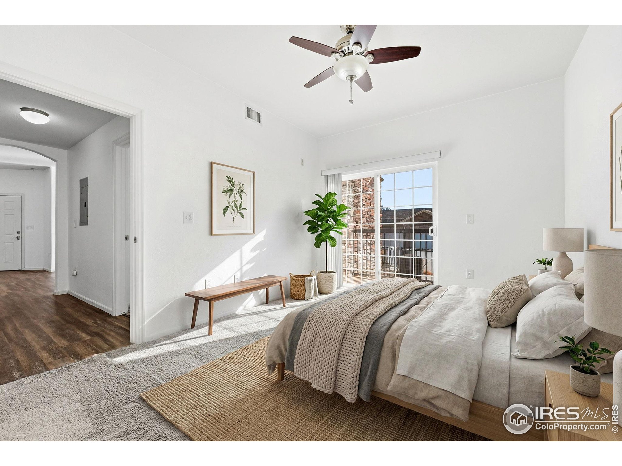 1425 Blue Sky Circle, Unit 15105 Erie, CO 80516 - Photo 20 of 45 a bedroom with a bed a window and a potted plant