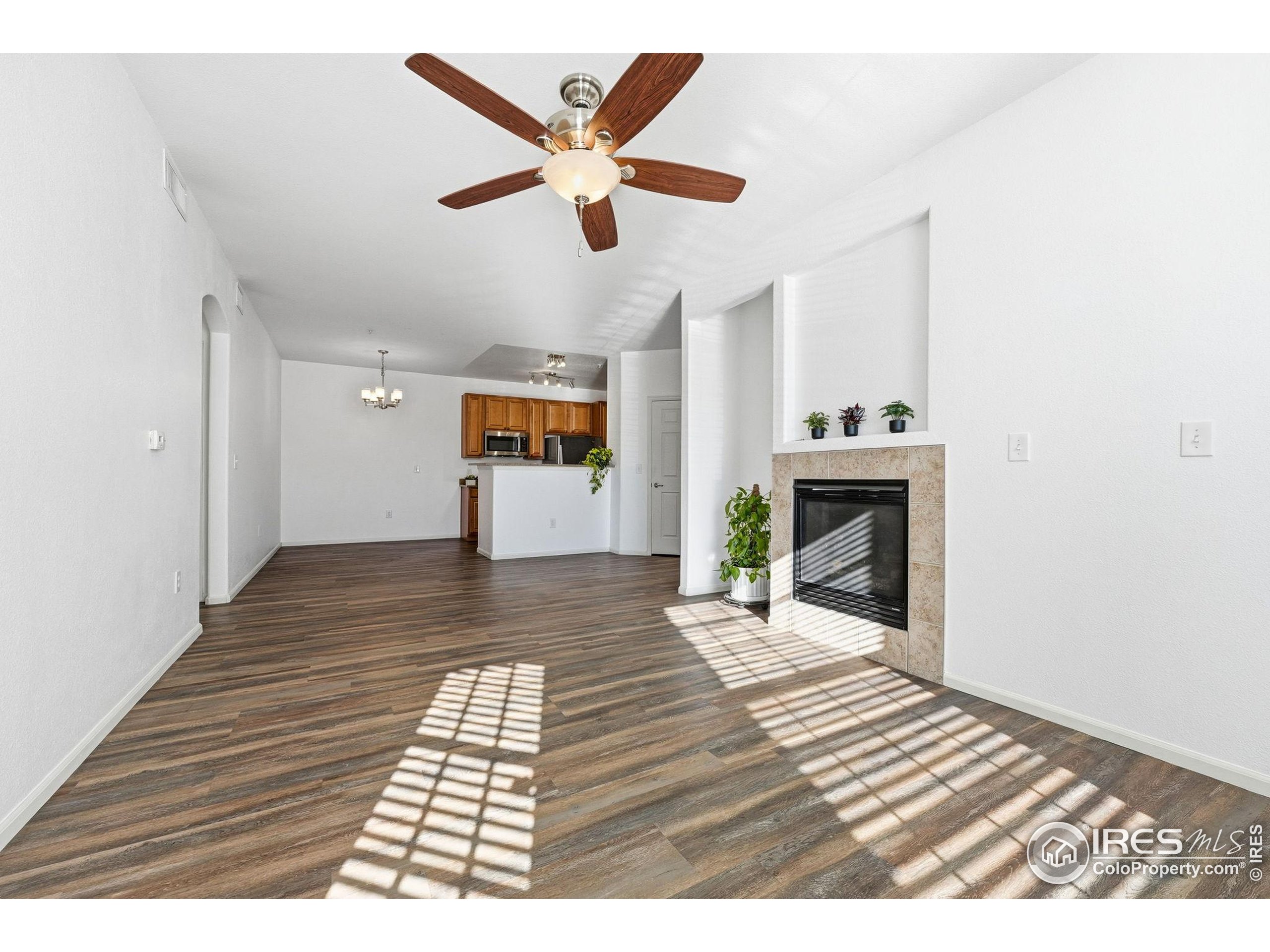 1425 Blue Sky Circle, Unit 15105 Erie, CO 80516 - Photo 2 of 45 a view of a livingroom with wooden floor