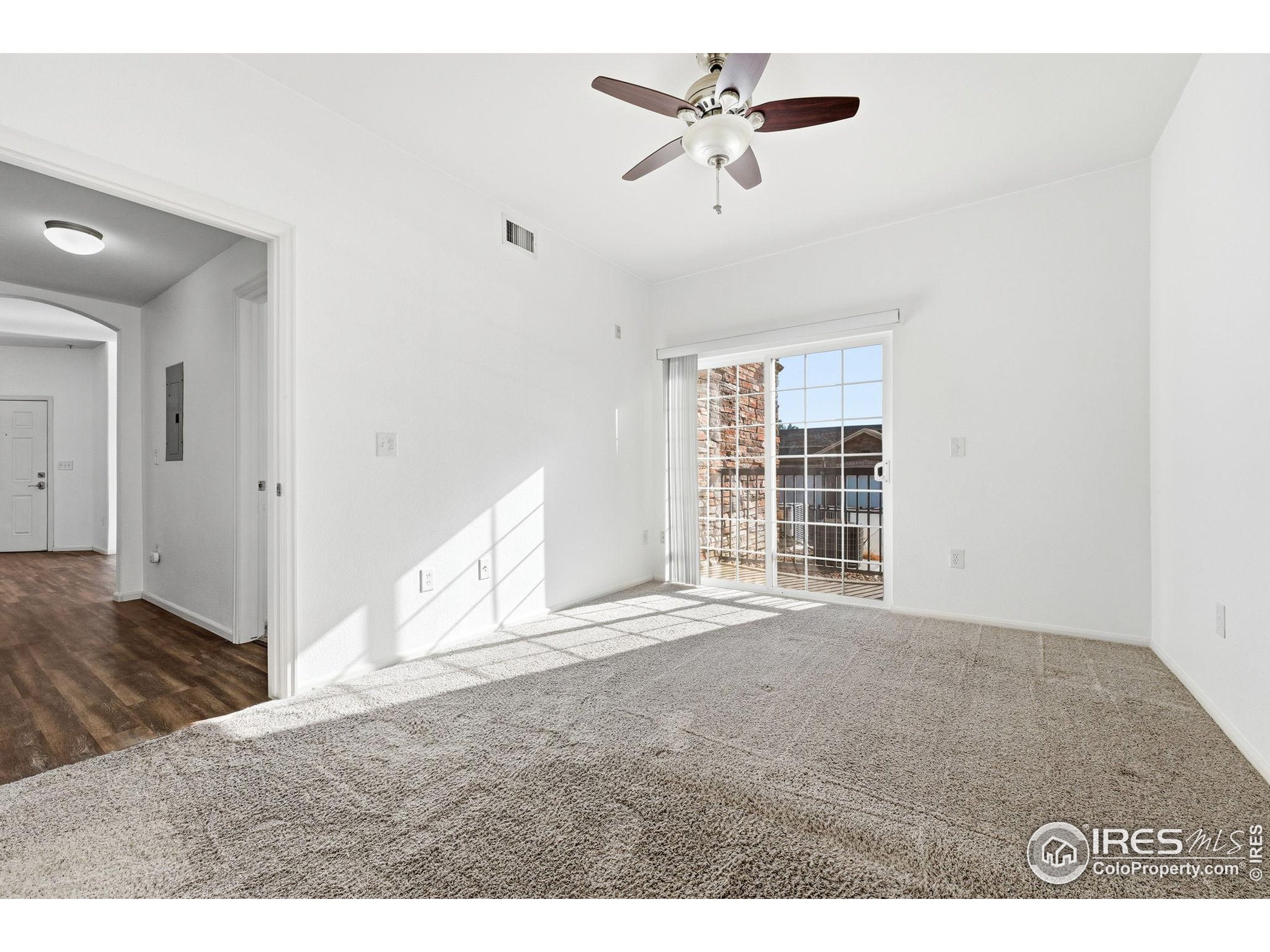 1425 Blue Sky Circle, Unit 15105 Erie, CO 80516 - Photo 21 of 45 a view of empty room with wooden floor and fan