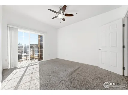 a view of a livingroom with a ceiling fan & wooden floor